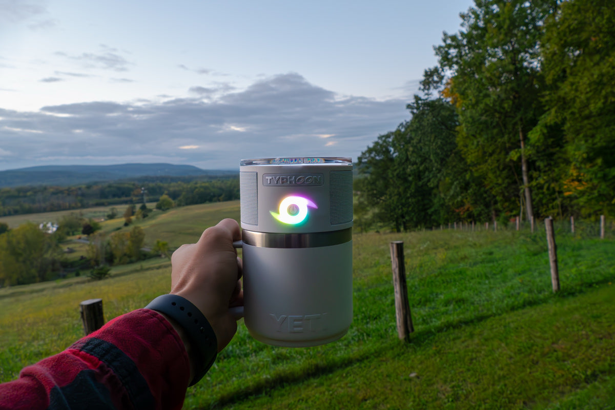 TYPHOON speaker on a tumbler mug at dusk